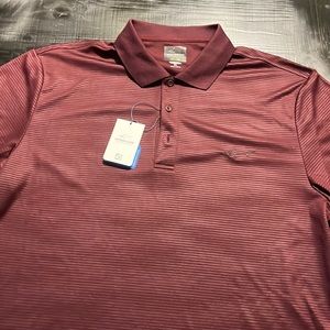 Greg Norman NWT Polo. Size is XL. Never washed or worn. New condition.